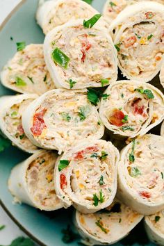 a plate filled with chicken salad rolls on top of a table