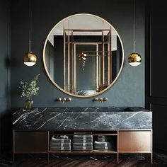 a bathroom with a marble counter top and gold fixtures on the wall, along with a round mirror