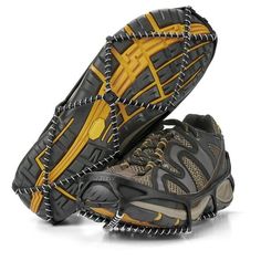 a pair of hiking shoes with yellow and black laces on the outstretches