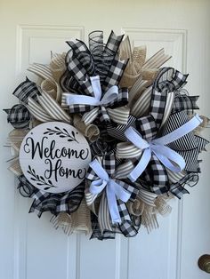 a welcome home wreath hanging on the front door