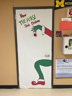 a classroom door decorated with the grin's costume