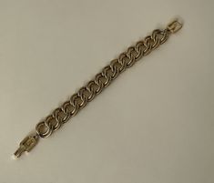 "Givenchy gold tone link chain bracelet  approximately - 8\" L with clasp x 5/8\" w.  Good vintage condition  marked: copyright symbol Givenchy  08/16/23 1428" Formal Metal Chain Link Charm Bracelet, Gold Metal Chain Bracelet For Formal Occasions, Formal Gold Metal Chain Bracelet, Formal Metal Charm Bracelet With Chain, Metal Link Chain Bracelet For Formal Occasions, Formal Metal Link Chain Bracelet, Formal Gold-tone Metal Chain Bracelet, Gold-tone Chain Metal Bracelet, Gold Cuban Link Bracelet With Chain