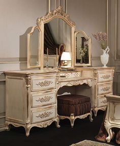 an antique style dressing table with mirror, stool and vase on it's side