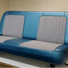 a blue and white couch sitting on top of a wooden table