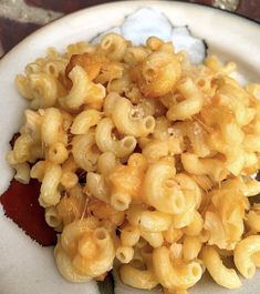 a white plate topped with macaroni and cheese