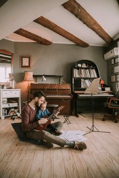 a man sitting on the floor playing an instrument