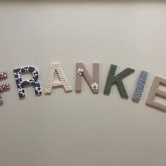 the word franklin spelled with letters made out of different types of beads on a white surface