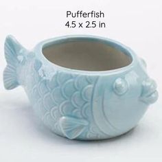 a ceramic fish cup is shown with measurements