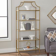 a living room with a couch, chair and shelving unit in gold metal frame