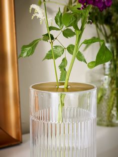 a vase with flowers in it sitting on a table