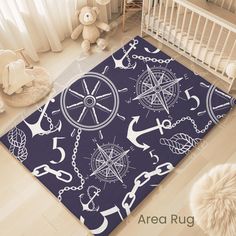 a baby's room with an area rug that has anchors and ships on it