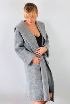 Wrap yourself in the warmth, comfort, and style of the Belen Alpaca Long Hooded Cardigan, a versatile knitwear piece designed to keep you warm and stylish throughout the seasons. Crafted from a luxurious alpaca blend, this cardigan/coat with a hood is elegant and sophisticated, making it perfect for both casual and dressier occasions. - Luxurious Alpaca Blend.- Fashionable and elegant design, the hood adds extra warmth and protection.- Practical pockets.- Versatile length that flatters all body Soft Knit Sweater Coat For Winter, Oversized Knit Warm Outerwear, Soft Knit Outerwear For Winter, Cozy Long Coat Sweater For Winter, Cozy Knit Winter Outerwear, Winter Knitted Cozy Fit Outerwear, Cozy Fit Knitted Winter Outerwear, Cozy Fit Knitted Outerwear For Winter, Knitted Cozy Fit Outerwear For Winter