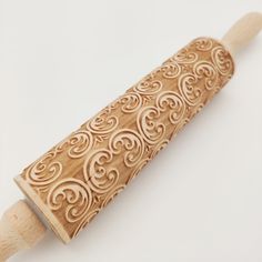 a wooden rolling pin with intricate designs on it