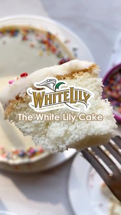 a piece of cake on a fork with the words white lily in front of it