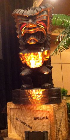 a statue made out of tires with flames in the center and lights on each side