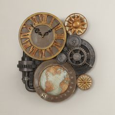 an assortment of clocks with different types of gears and dials on the sides, including a world map