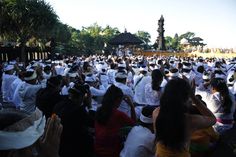 a large group of people sitting on the ground