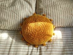 a yellow pillow sitting on top of a bed