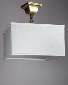 a white lamp hanging from the ceiling with a square light fixture on it's side