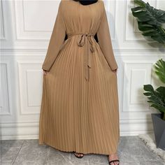 This beautiful nida pleated jumpsuit dress is the perfect outfit for any occasion. Includes with a belt, wide legged pants, long-sleeved arms, and a chiffon dress overlay. Available in 5 colours. Pleated Long Sleeve Chiffon Maxi Dress, Pleated Chiffon Maxi Dress With Long Sleeves, Long Sleeve Pleated Chiffon Maxi Dress, Beige Pleated Maxi Dress For Party, Beige Pleated Maxi Dress, Long Sleeve Maxi Dress With Pleated Waist For Summer, Brown Belted Dress For Spring, Summer Long Sleeve Maxi Dress With Pleated Waist, Spring Brown Dress With Belt