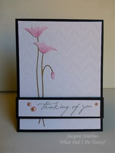 a card with two pink flowers on it and the words thinking out you written in black ink