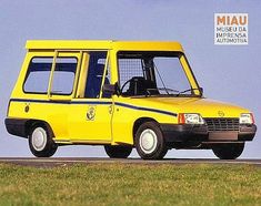 a yellow van driving down a road next to a grass covered field in front of a blue sky