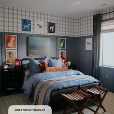 a bed room with a neatly made bed and pictures on the wall