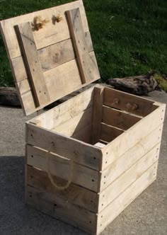 an open wooden box sitting on the ground