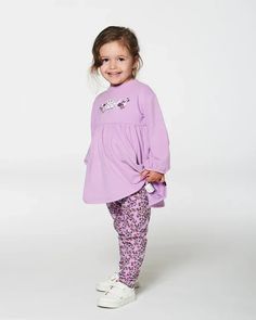 Our Tunic and Printed Leggings Set Lilac Mini Flowers is perfect for the little girl with a big sense of style! This comfy set features a long sleeve tunic top with a shirred empire waistband, a round neckline, and a kitty cat and flower print on the chest. A stretchy allover print legging with an elastic waistband completes the look! Elastic Waist Leggings, Girls Tunics, Mini Flowers, Tunic Leggings, Comfy Sets, Leggings Set, Fashion Now