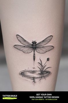 a black and white photo of a dragonfly on the side of a woman's leg