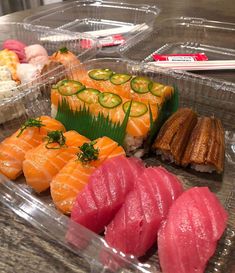 some sushi and other food items in plastic containers