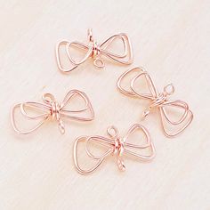 four pieces of metal with bows on them