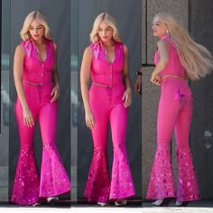 a woman in pink outfit standing next to a building with her hands on her hips