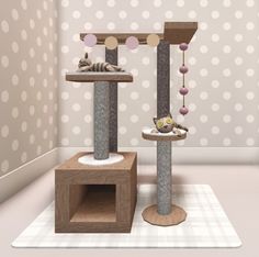 a cat tree with two cats in it and some balls on the wall behind it