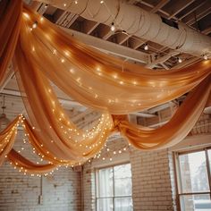 the ceiling is decorated with lights and draping