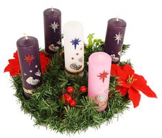 a wreath with candles and poinsettis on it