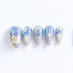 Step into a frosty fairytale with our Winter Wonderland press-on nails, a breathtaking combination of icy blues, glistening glitter, and intricate white details. Each nail captures the essence of a magical winter scene, with delicate snowflakes, twinkling stars, and a charming snowy village design. The shimmering base provides a radiant glow, reminiscent of snow-covered landscapes under a starry sky. These nails are perfect for anyone looking to add a dash of winter magic to their style. With their intricate detailing and sparkling finish, "Winter Wonderland" is sure to elevate your look for any holiday party, winter getaway, or cozy night in. 🎀 With every order we send an Essentials Tool Kit for free! What's included in the kit: 1 nail file  1 wooden stick  1 sheet with 24 sticky tabs 2 Iridescent Snowflake Nails, White Blue Christmas Nails, Snow Gel Nails, Pink And Blue Winter Nails, Silver And Blue Christmas Nails, Iridescent Christmas Nails, Winter Ice Nails, Tanzanite Nails, Frosty Winter Nails