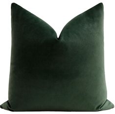 a dark green pillow on a white background