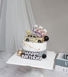 a birthday cake with money on top