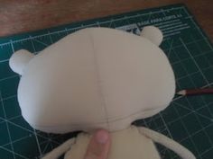 someone is making a stuffed animal that looks like a bear