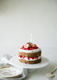 a cake with strawberries and whipped cream on top