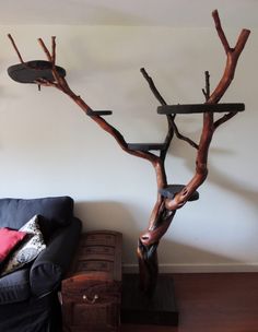 a living room with a couch and a tree sculpture