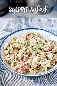 a white bowl filled with chicken salad on top of a blue and white table cloth