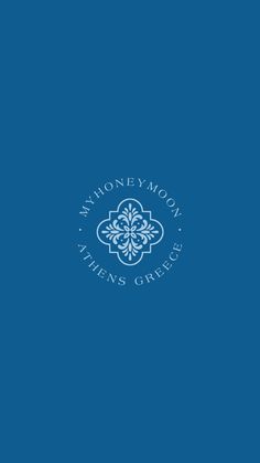 the monogram logo on a blue background with white letters and an ornate flower design