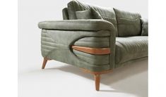 an upholstered green couch with wooden legs