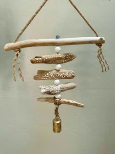 a mobile made out of driftwood and beads