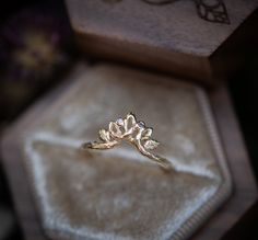 a gold ring sitting on top of a velvet box