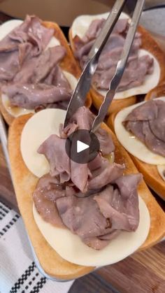 an open faced sandwich with meat on it and a knife sticking out of the top