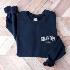 Celebrate your love and pride with our personalized embroidered sweatshirts, perfect for every grandpa, pop pop, and papa! These cozy, varsity-style sweatshirts make an ideal Father's Day or Christmas gift, featuring custom embroidery that adds a unique, personal touch just for him. Designed for comfort and style, this sweatshirt lets him proudly show off his special role. Give the grandpa in your life a gift as warm as his hugs--perfect for grandfathers who cherish family memories and love stay Nana Sweater, Grandma Mothers Day Gift, Style Sweatshirts, Parents Gifts, Grandma Sweatshirt, Grandfather Gifts, Winston Salem Nc, Embroidery Sweater, Varsity Style