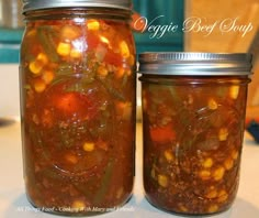 two jars filled with food sitting on top of a table